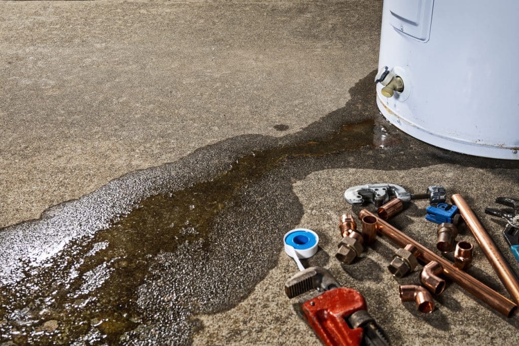 water heater sitting on a concrete floor